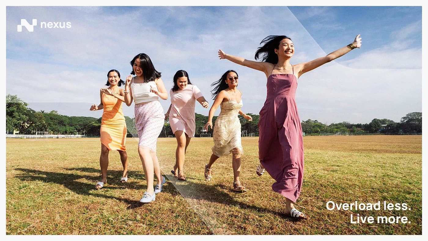 Five friends running across an open field on a bright day, arms out, under the Nexus line “Overload less. Live more.”