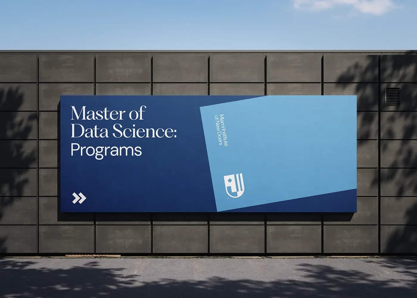 A navy and pale-blue billboard for a Master of Data Science programme on a concrete wall.