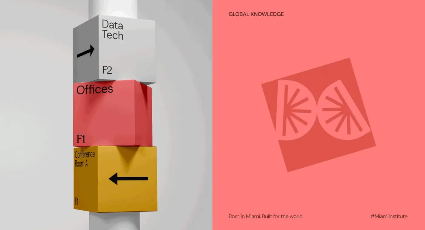 Stacked white, coral and yellow wayfinding cubes on a post, carrying floor directions.