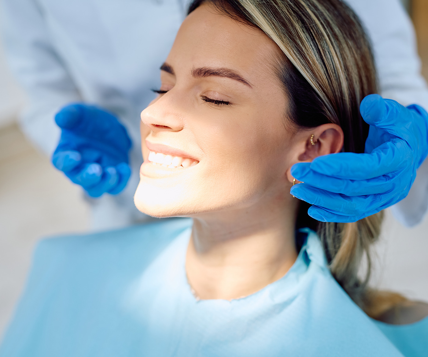 A patient resting with her eyes closed while treatment goes on.