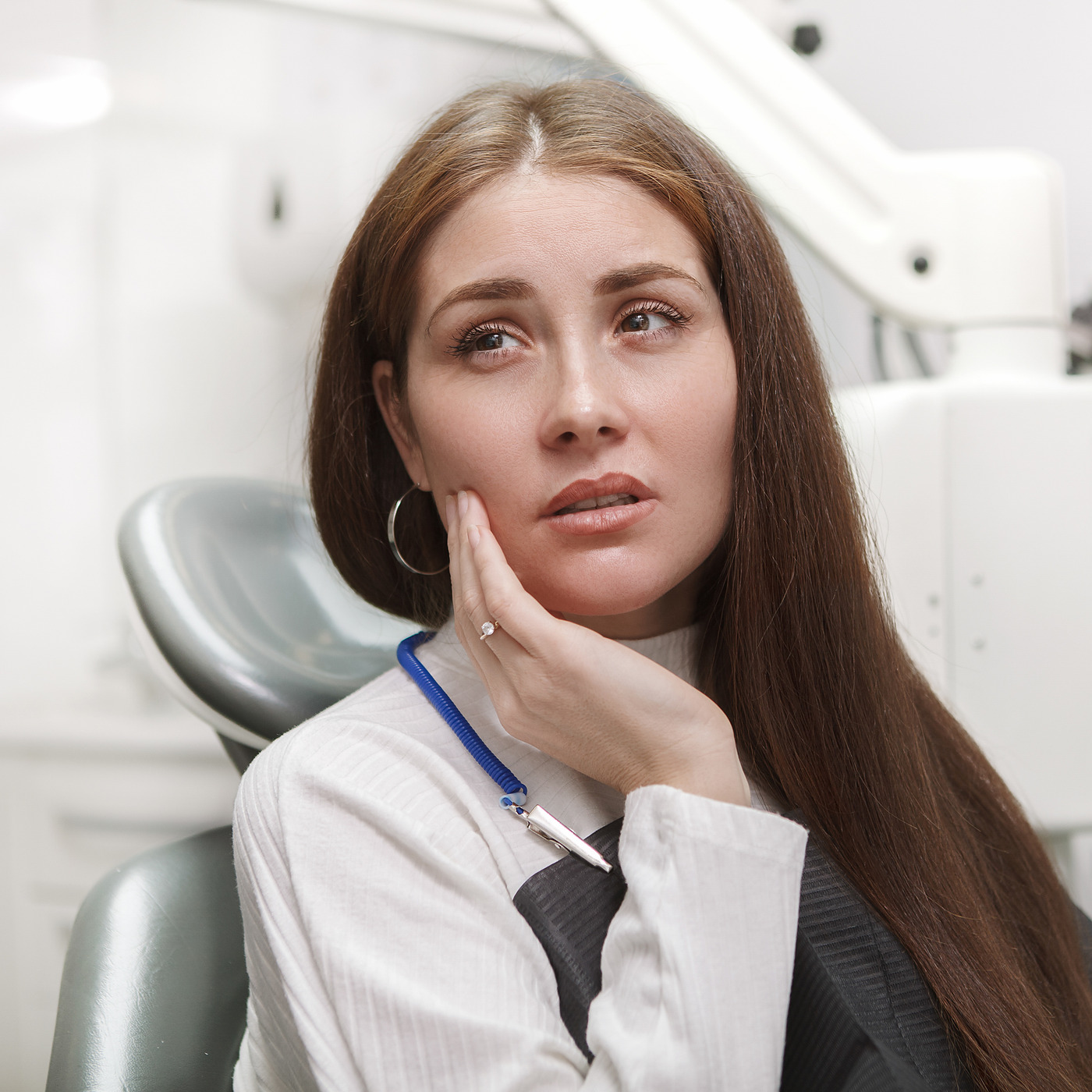 A patient with a toothache waiting in the chair at the dentist's office.