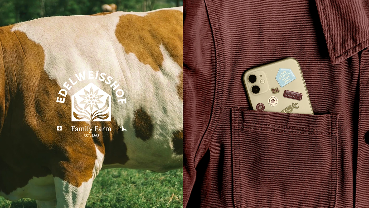 The Edelweisshof crest in white over a close photograph of a brown-and-white cow, beside a phone in a maroon chore-coat pocket covered in farm stickers reading “Less scroll more soil” and “Meet me in the mountains”