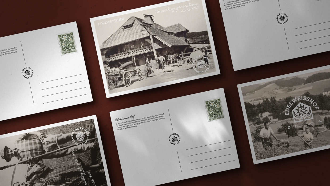 Edelweisshof postcards fanned across an oxblood surface — archival farm photographs on the front, ruled address panels and the circular crest on the back, with an edelweiss postage stamp