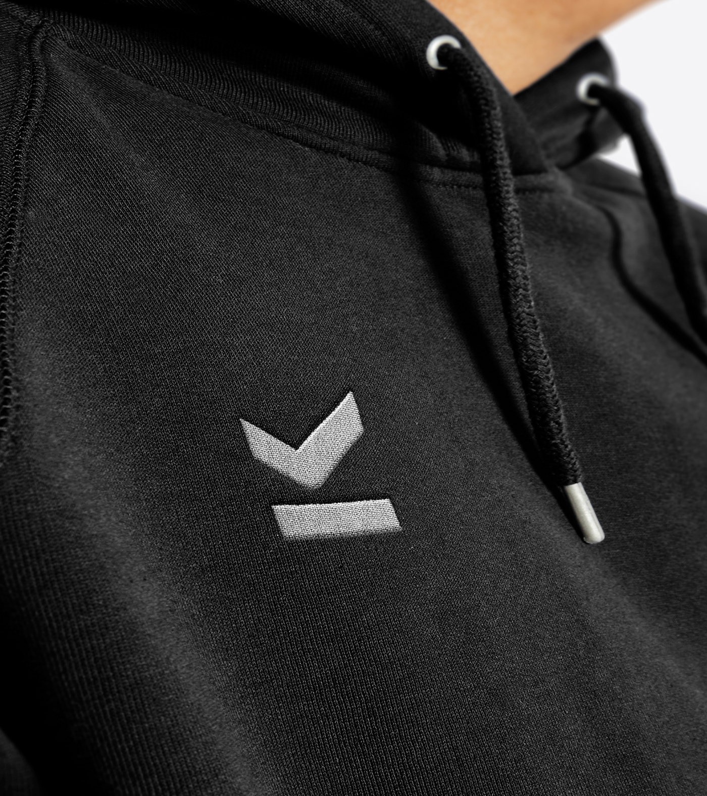 The Mark OS logomark embroidered in grey thread on a black hoodie