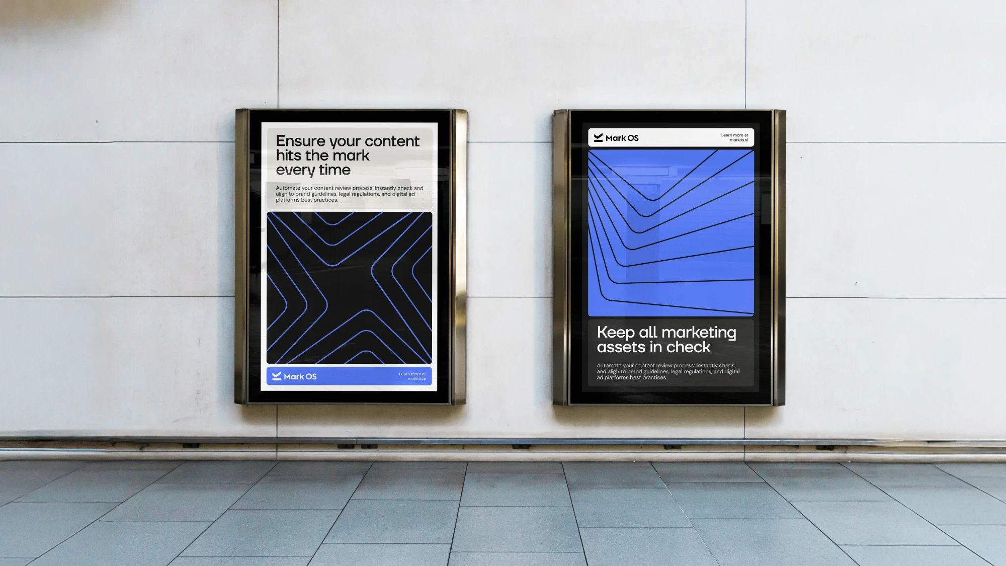 Two backlit Mark OS posters mounted on a pale stone wall, one light and one dark, both carrying the chevron pattern