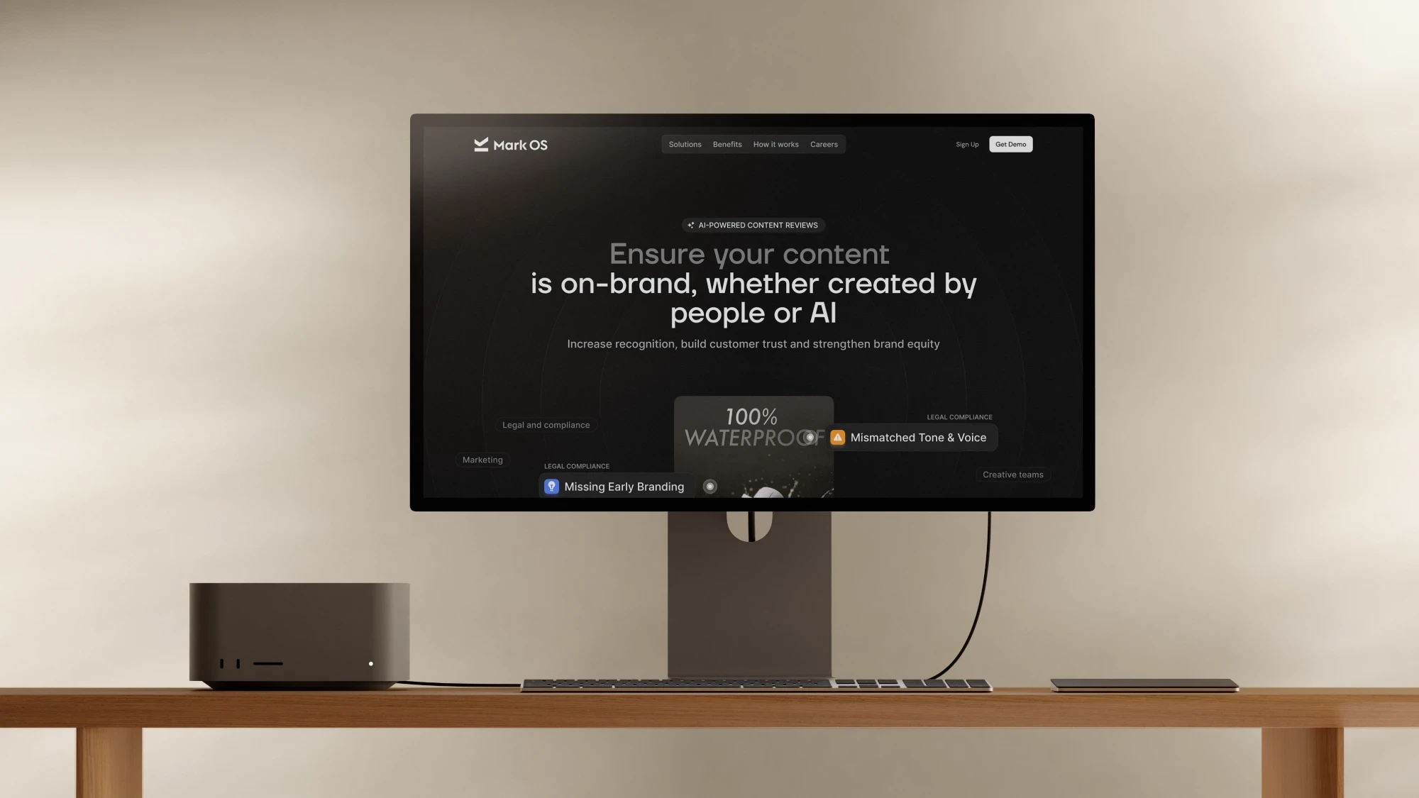 The Mark OS site in dark mode on a studio display: “Ensure your content is on-brand, whether created by people or AI”