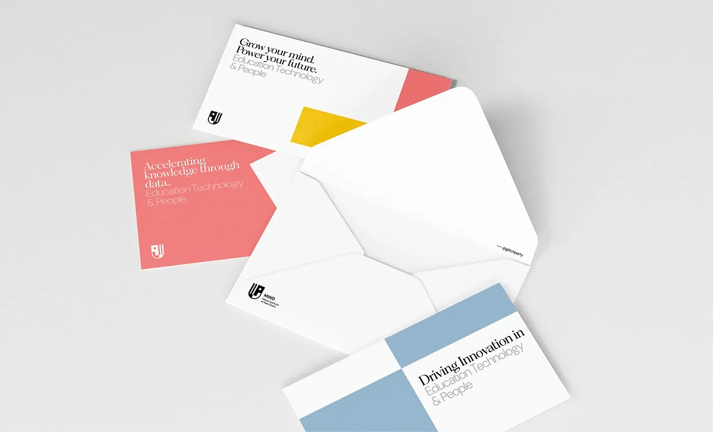 An opened white envelope with three colour-blocked correspondence cards on grey.