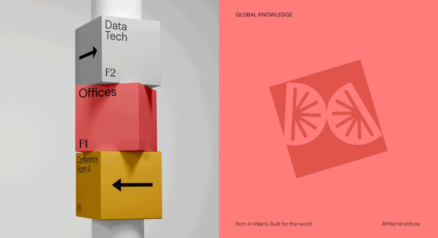 Stacked white, coral and yellow wayfinding cubes on a post, carrying floor directions.