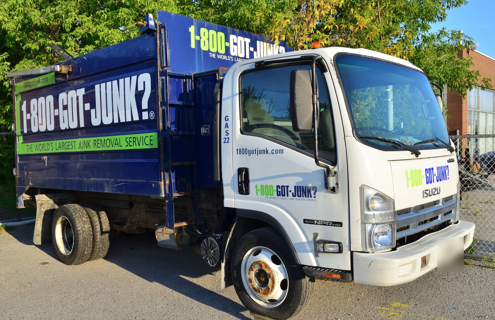 Blue-and-white 1-800-GOT-JUNK? truck with the company name, which is also its phone number, painted large on the box